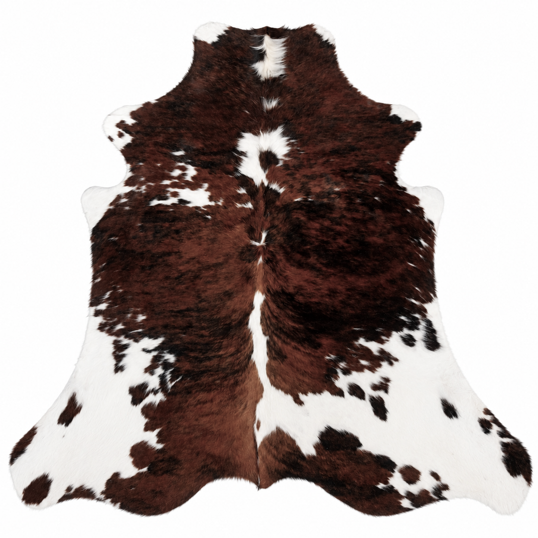 Brown and white cowhide rug on a white background
