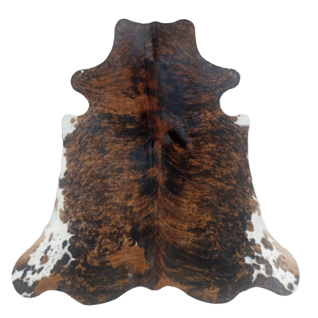 Cowhide rug with brown and black pattern on a white background