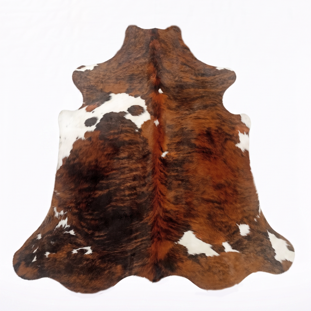 A natural cowhide rug with a brown and white mottled pattern, displayed flat against a white background.