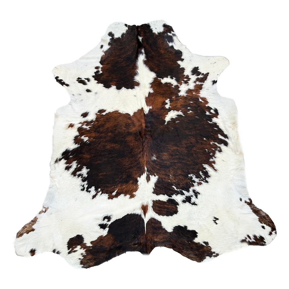 A natural cowhide rug with a classic brown and white mottled pattern, laid flat against a solid white background.