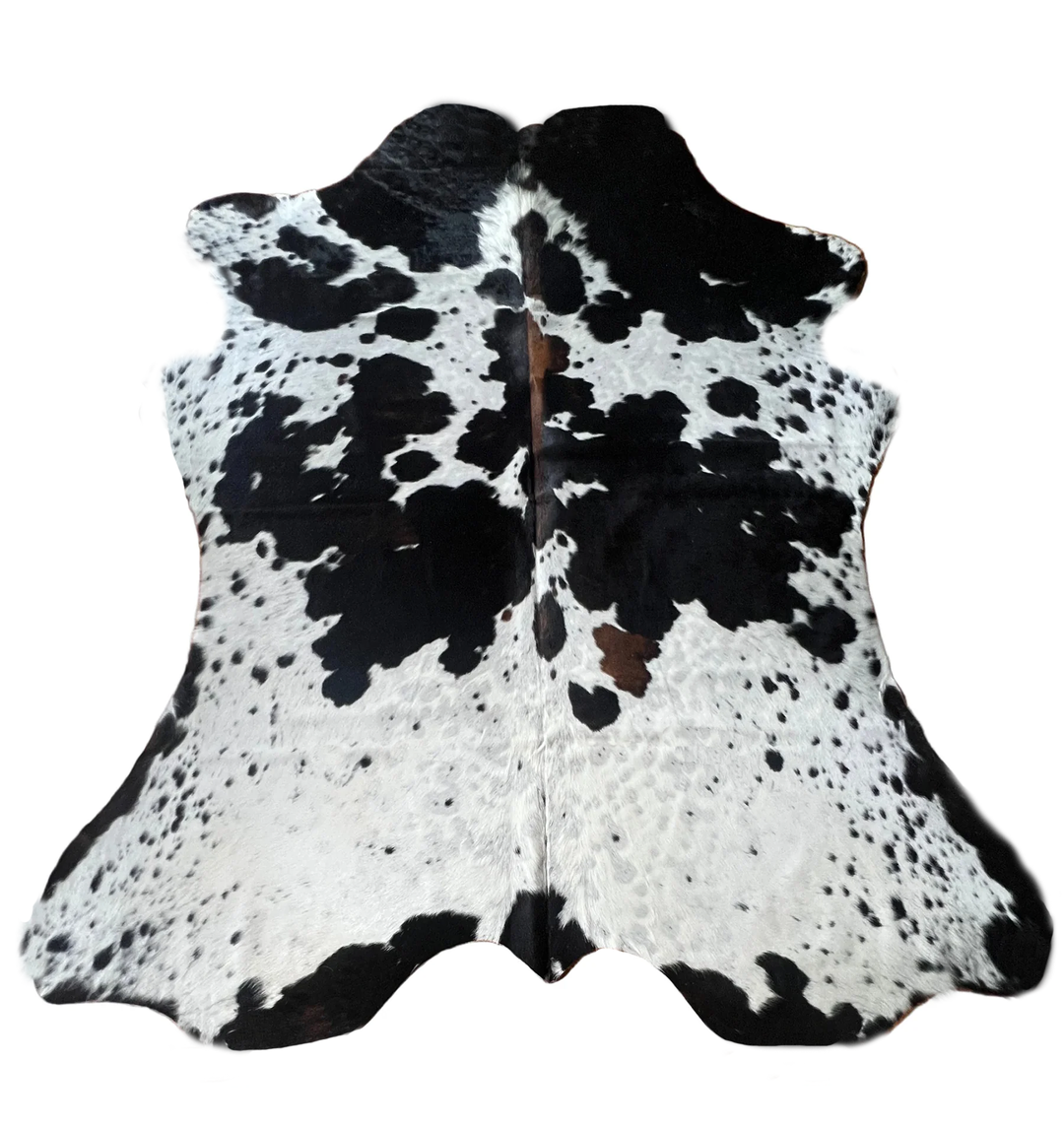 Black and white cowhide rug with a natural spotted pattern,
