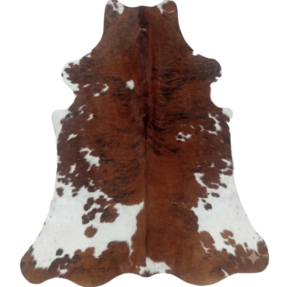 Brown and white cowhide rug on a white background