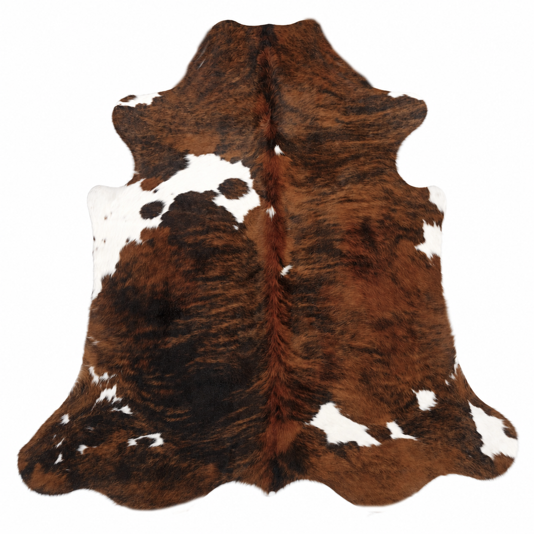 Brown and white cowhide rug on a white background