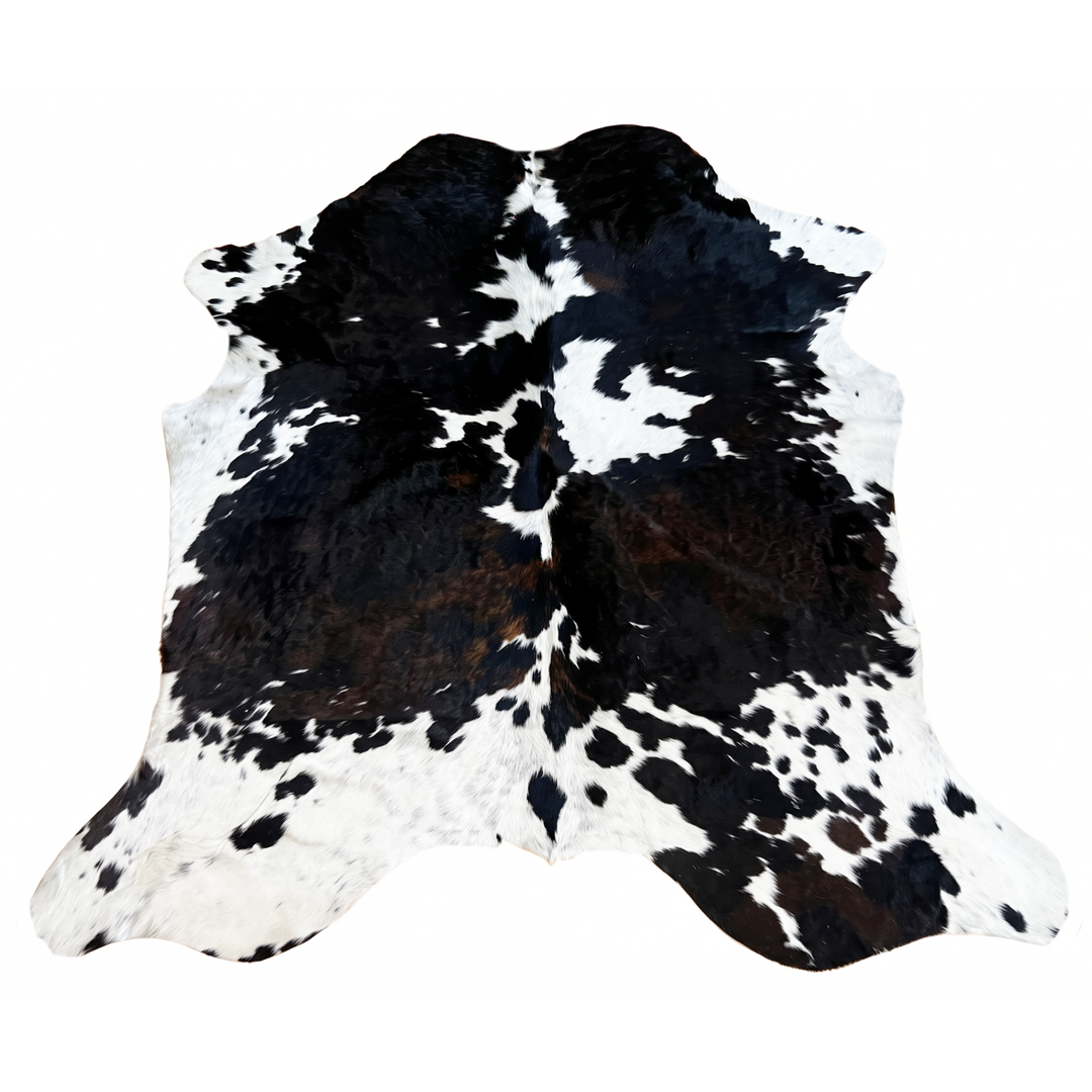 A black and white cowhide rug with a natural spotted pattern,