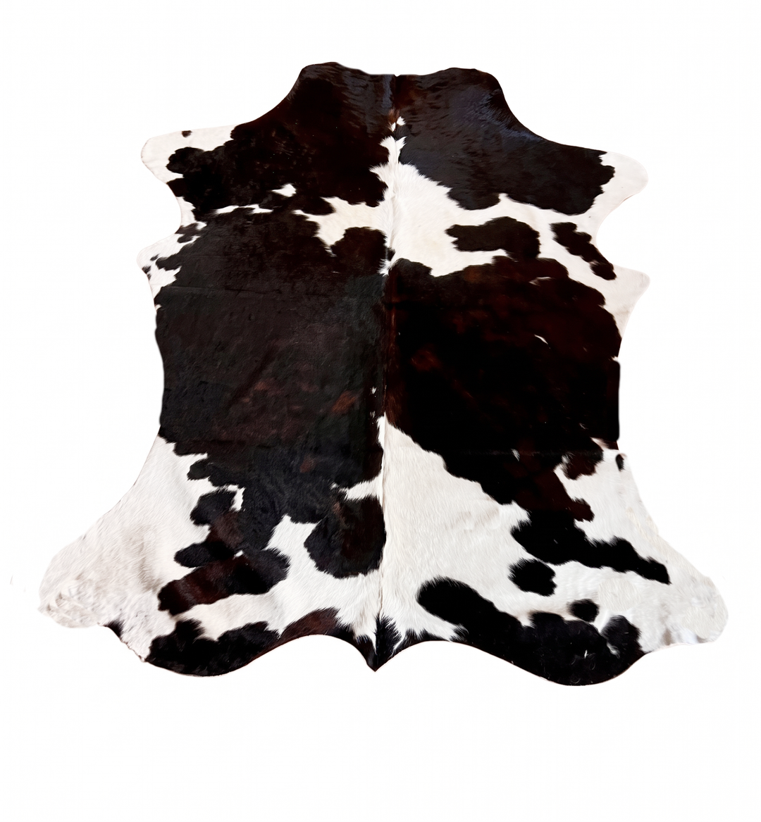 A black and white cowhide rug with a natural hair-on-hide pattern,