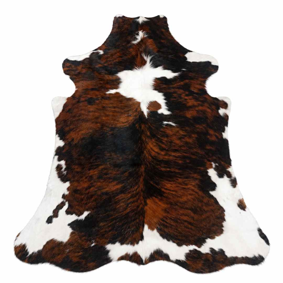 Brown, black, and white cowhide rug on a white background