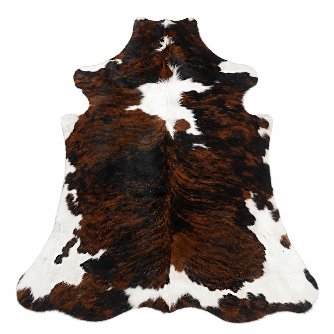 Brown, black, and white cowhide rug on a white background