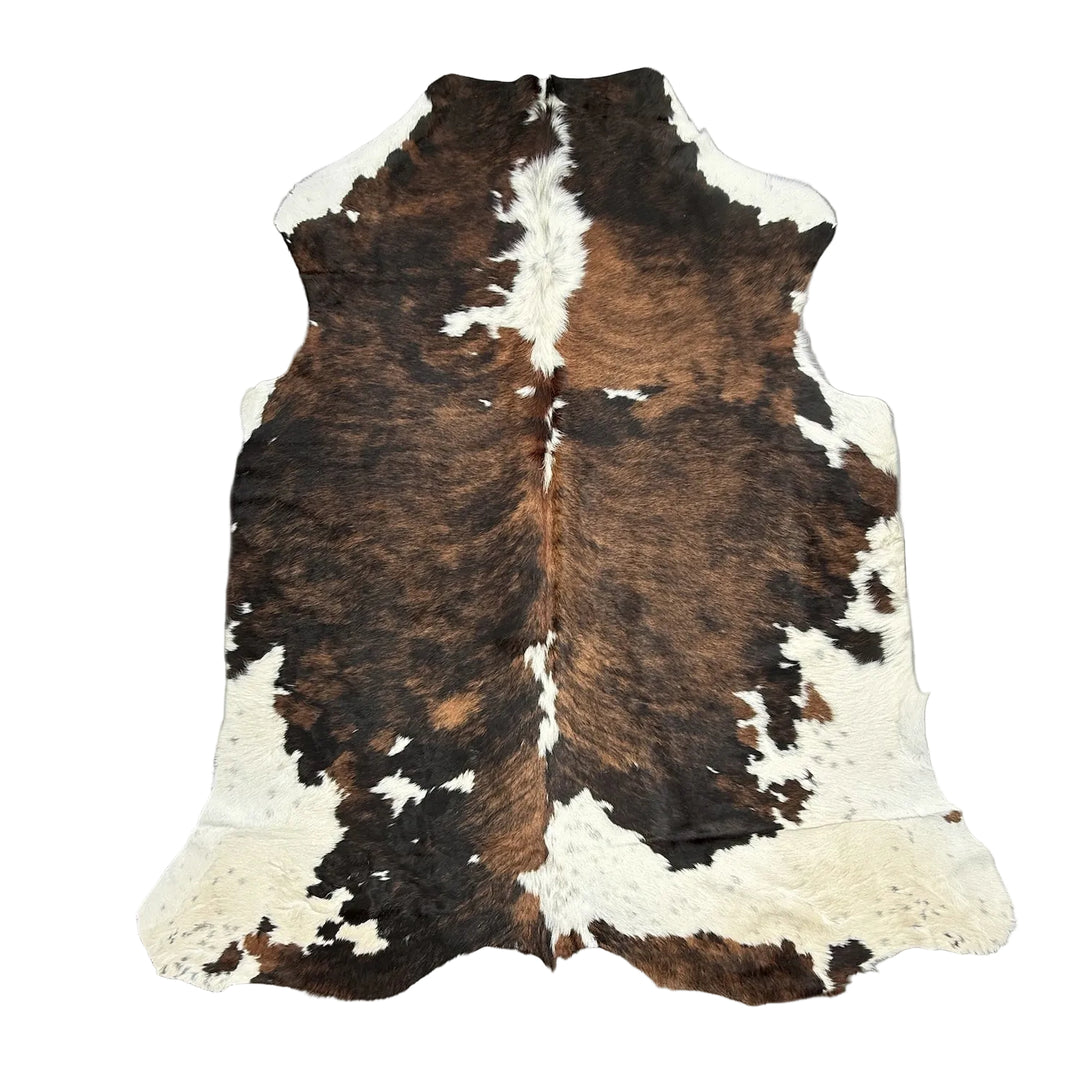 Large premium cowhide rug from Cowhide Rugs London, measuring 205cm by 180cm, with a natural, textured cowhide appearance.