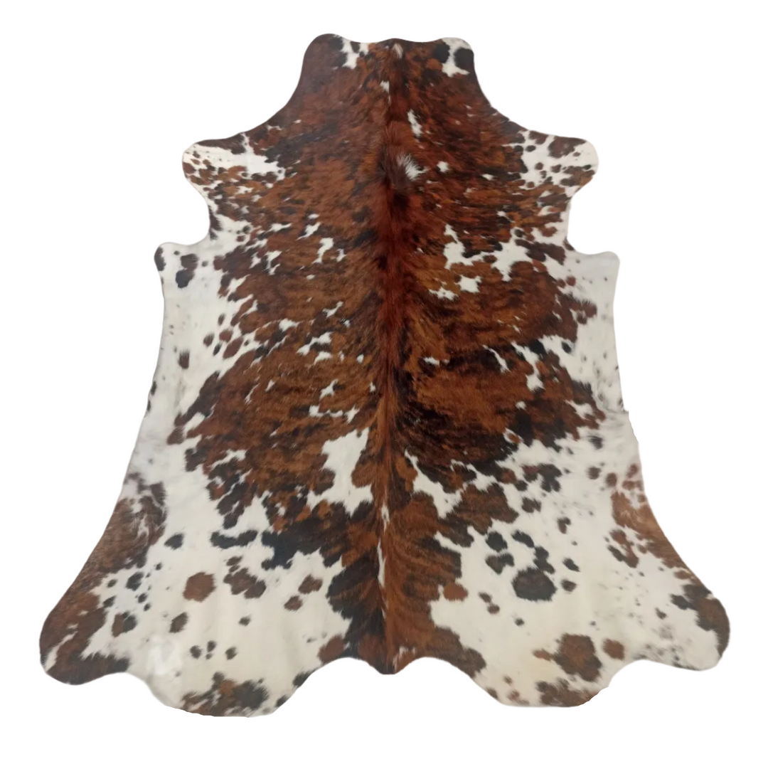 A natural cowhide rug with a brown and white mottled pattern,