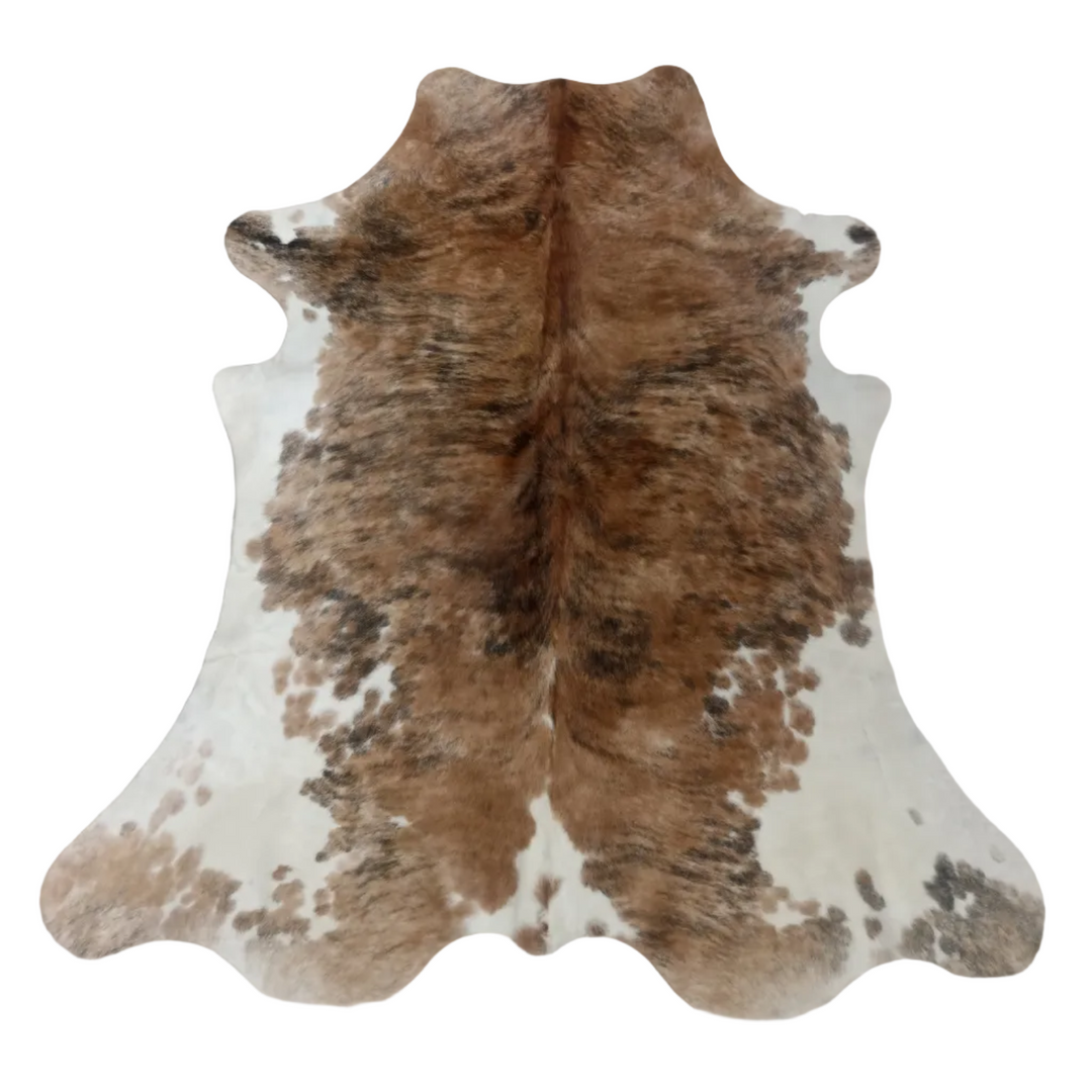 A natural cowhide rug with a mottled pattern of brown, tan, and white patches, 