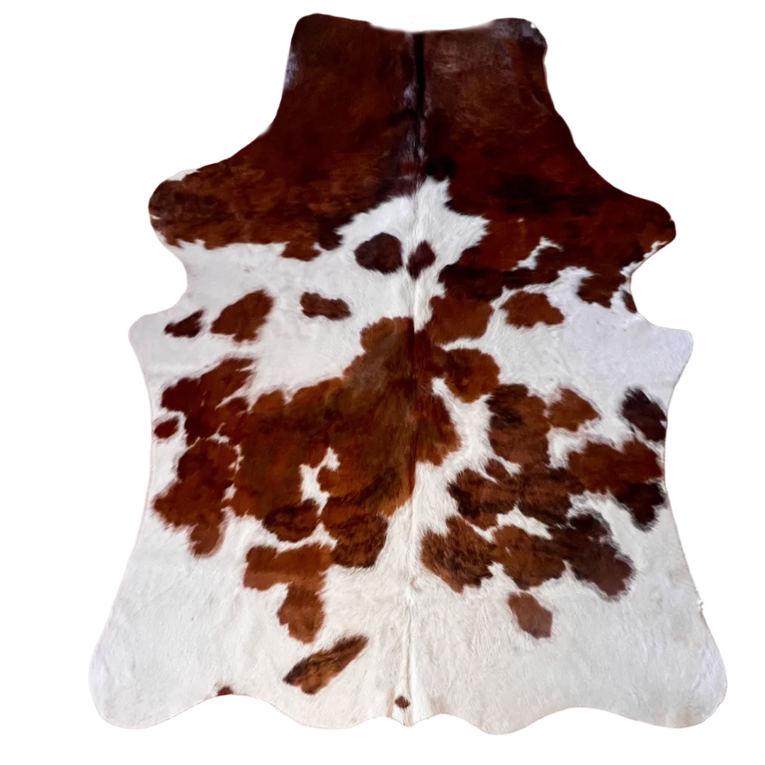 Brown and white cowhide rug with natural hair-on-hide texture,