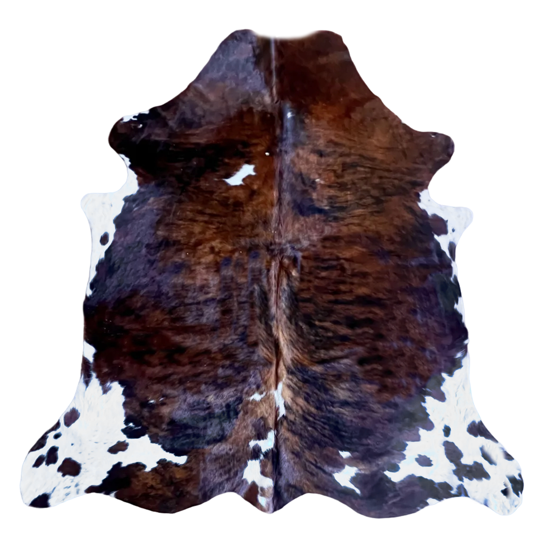 Brown and white cowhide rug with natural irregular patches and a dark center seam, isolated on a white background