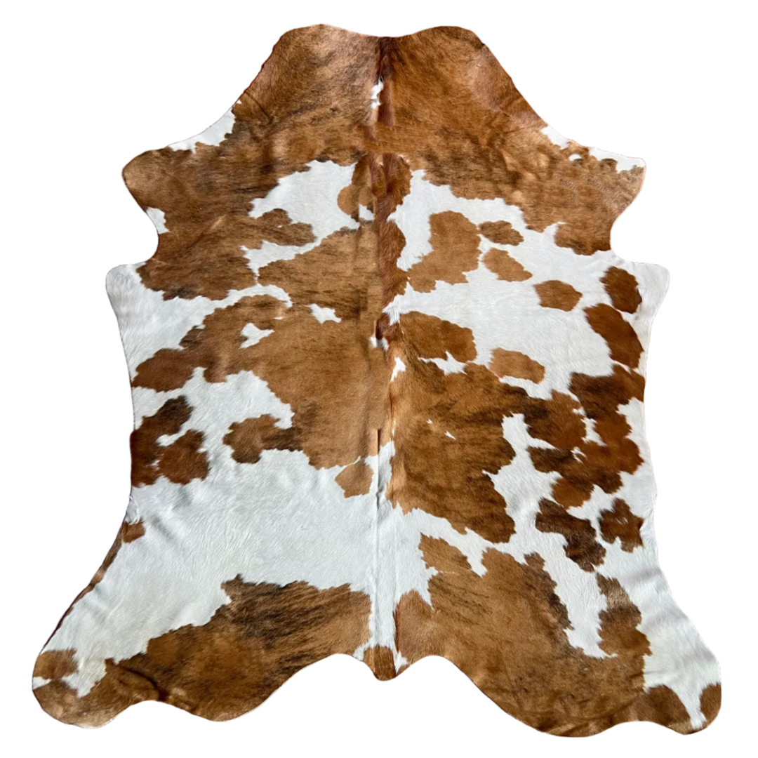 Brown and white cowhide rug with a natural mottled pattern, 