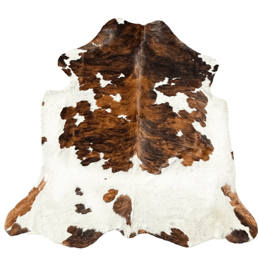 A natural cowhide rug with a classic brown and white spotted pattern, 
