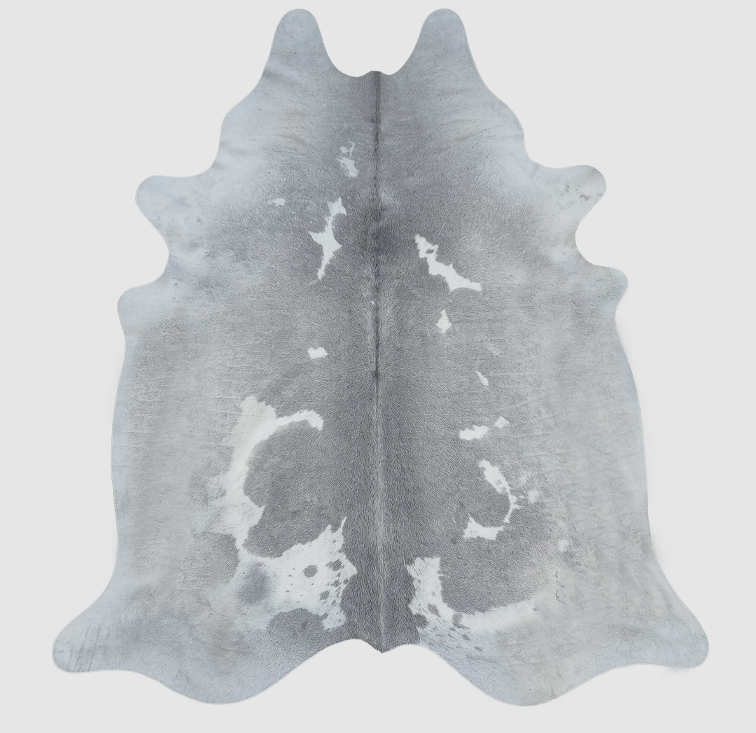 A natural cowhide rug with a gray and white mottled pattern, 