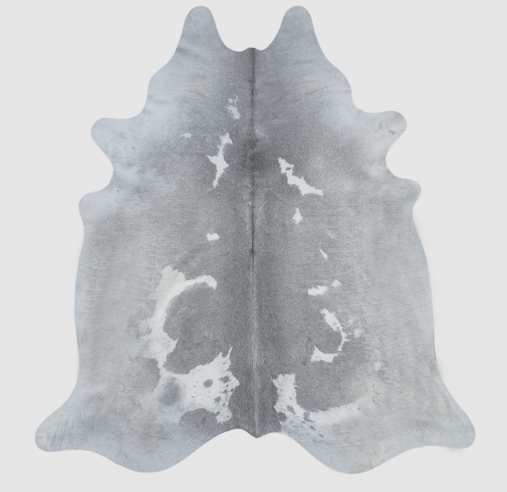 A natural cowhide rug with a gray and white mottled pattern, 
