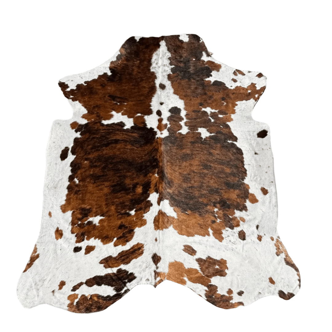 A natural black and white , brown cowhide rug with brown undertones