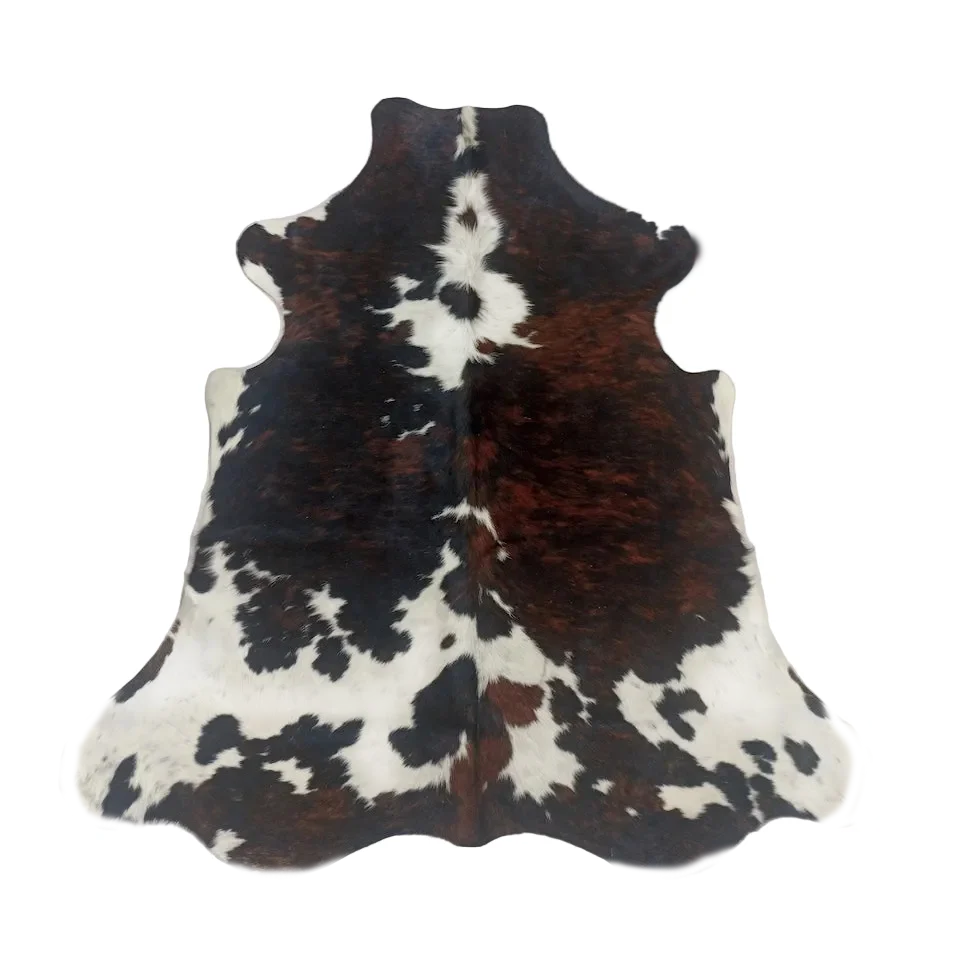 Cowhide rug with black, brown, and white pattern on a white background